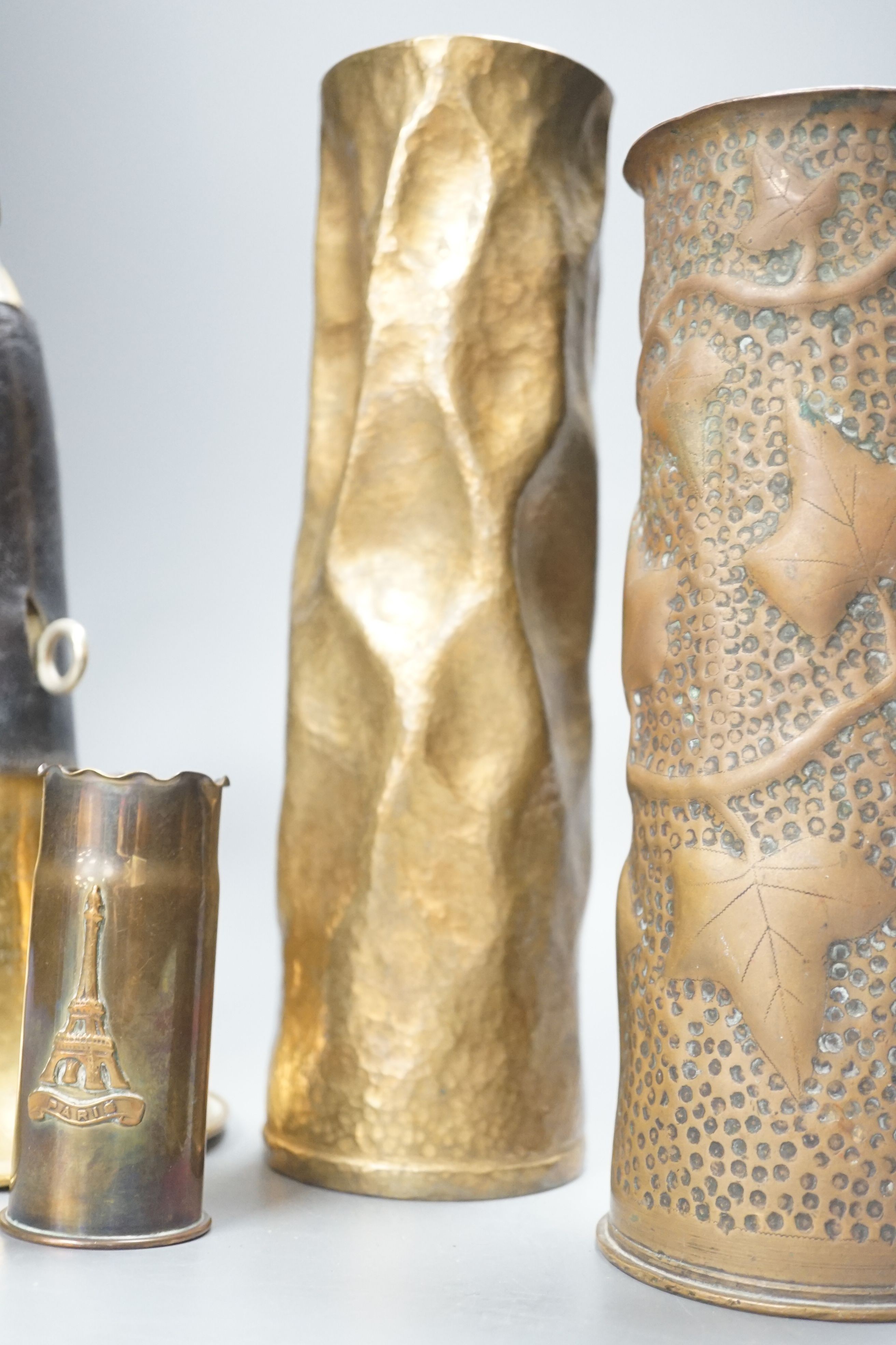 Three WWI brass trench art shell cases and a Couesnon & Cie brass bugle